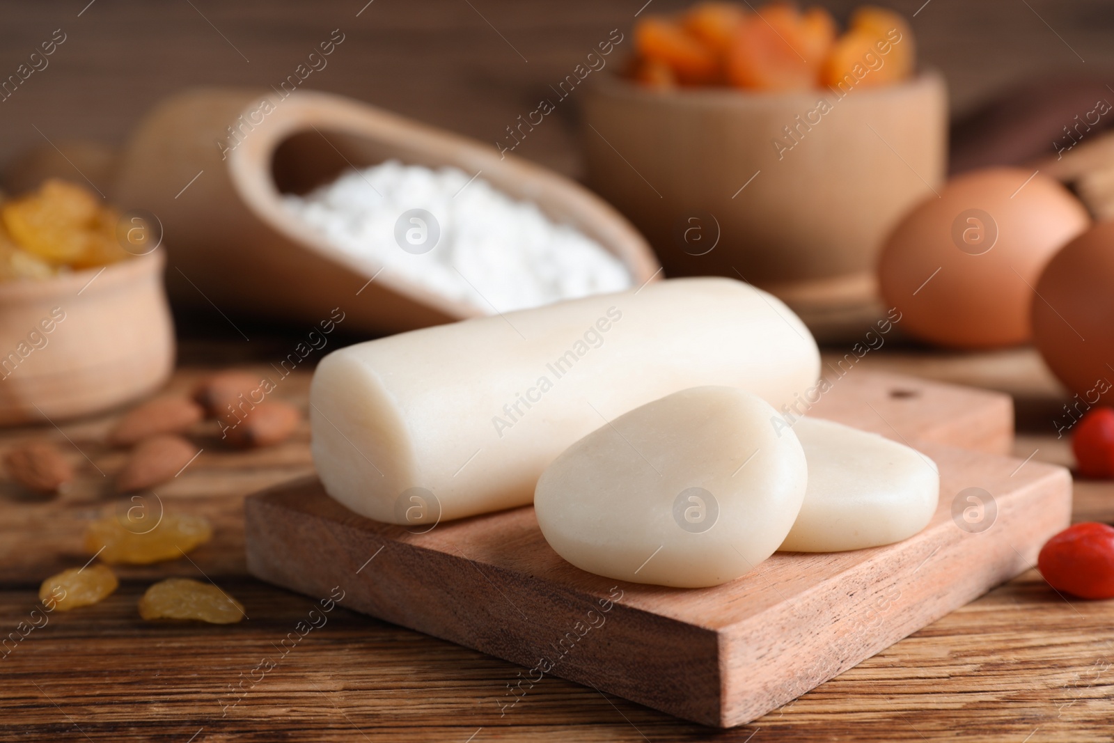 Photo of Marzipan and other ingredients for homemade Stollen on wooden table. Baking traditional German Christmas bread