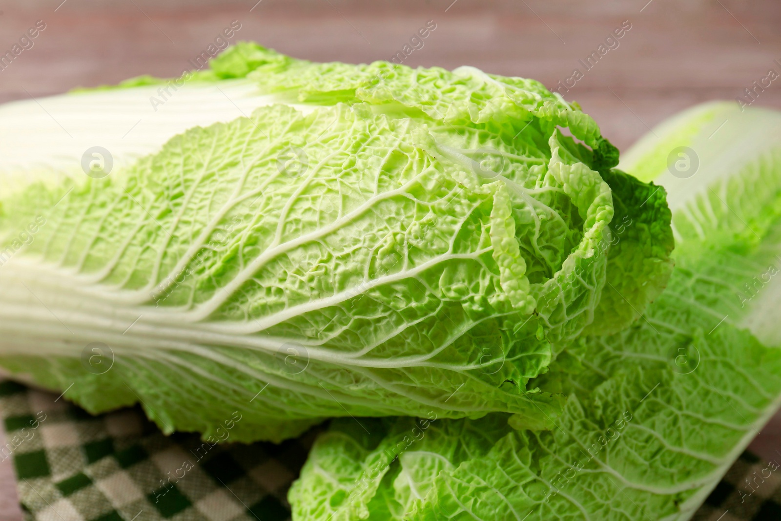 Photo of Fresh ripe Chinese cabbages on table, closeup