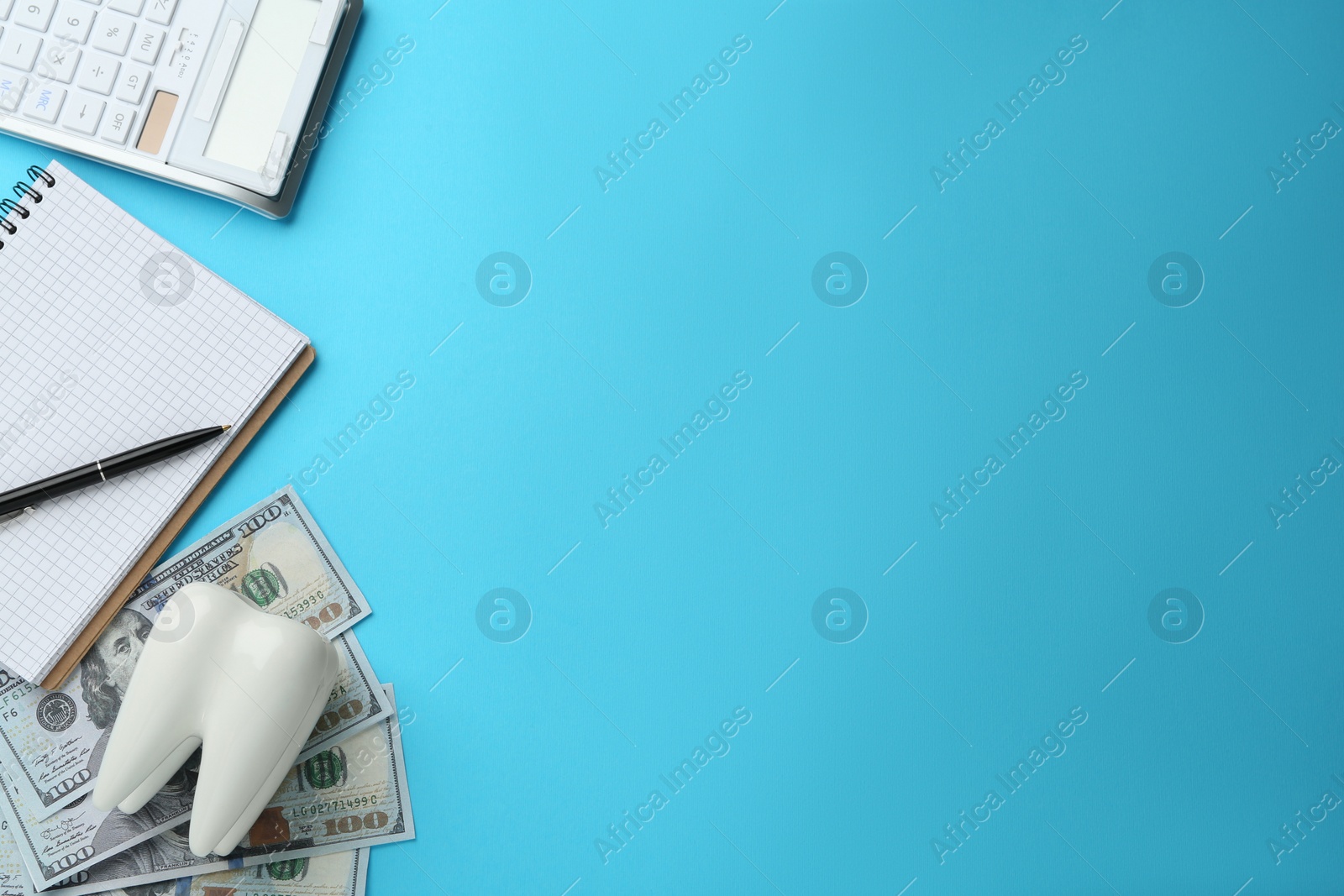 Photo of Flat lay composition with ceramic model of tooth and money on light blue background, space for text. Expensive treatment