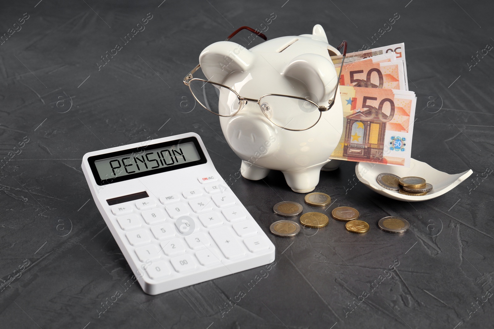 Image of Calculator with word Pension, broken piggy bank and money on grey background