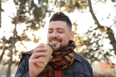 Photo of Man with cup of coffee in morning outdoors