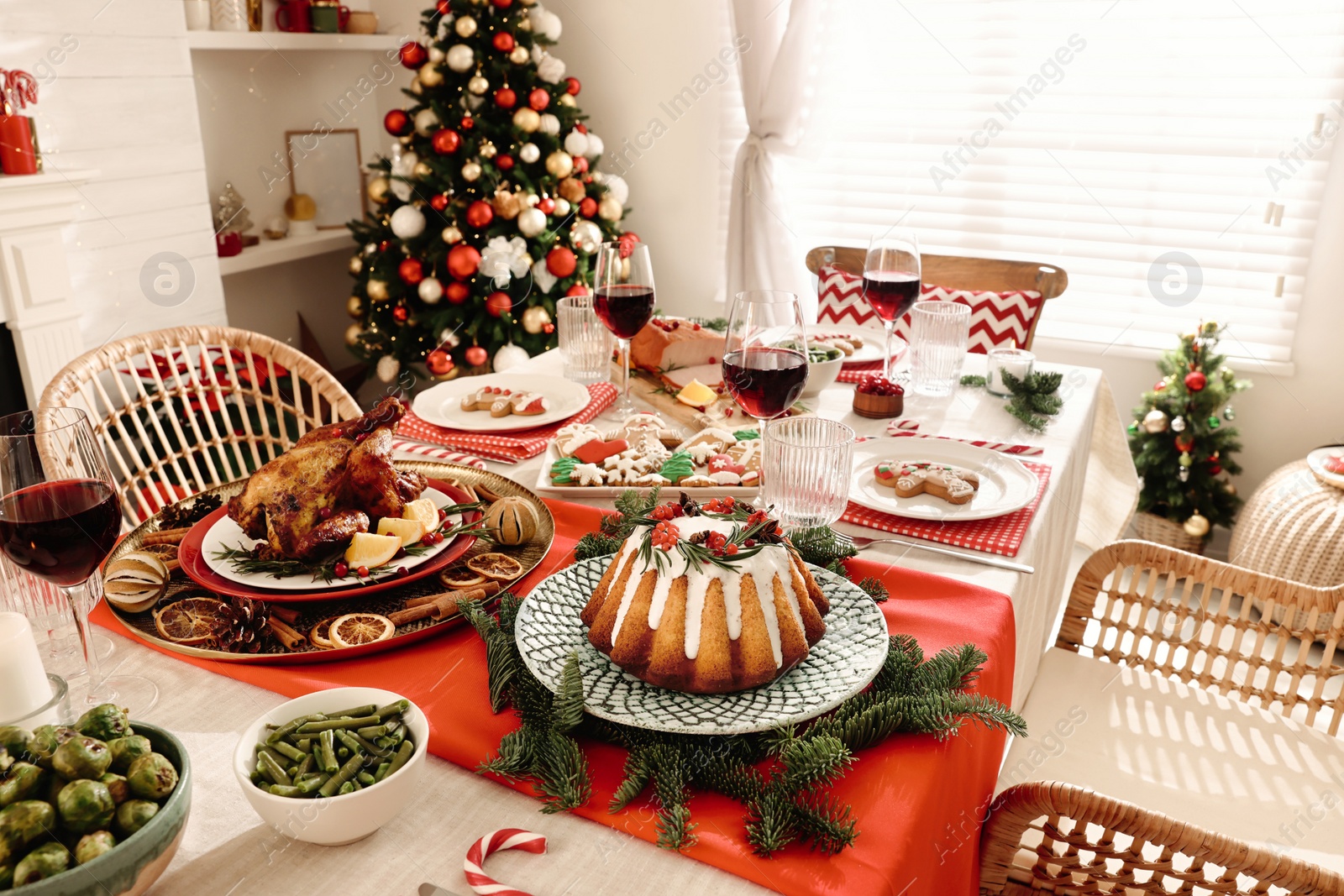 Photo of Festive dinner with delicious food and wine on table indoors. Christmas Eve celebration