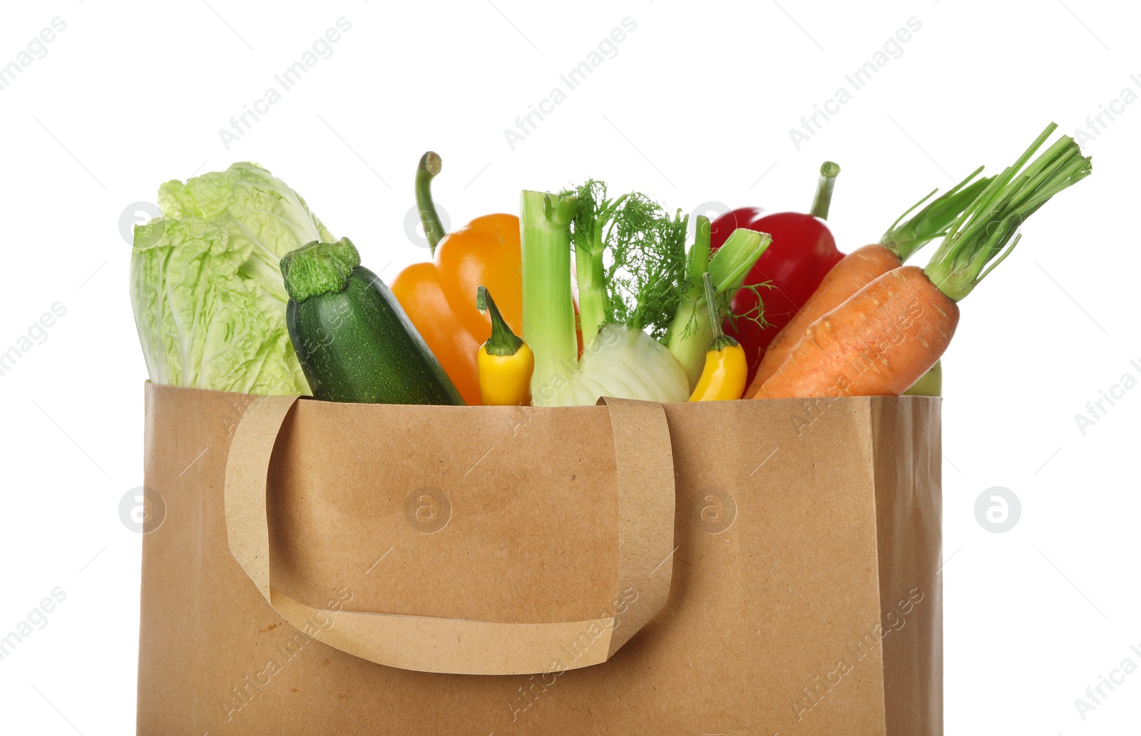 Photo of Paper bag with vegetables on white background, closeup