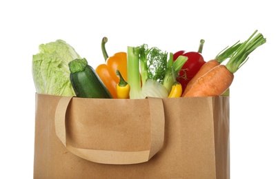 Photo of Paper bag with vegetables on white background, closeup