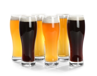 Photo of Glasses with different beer on white background