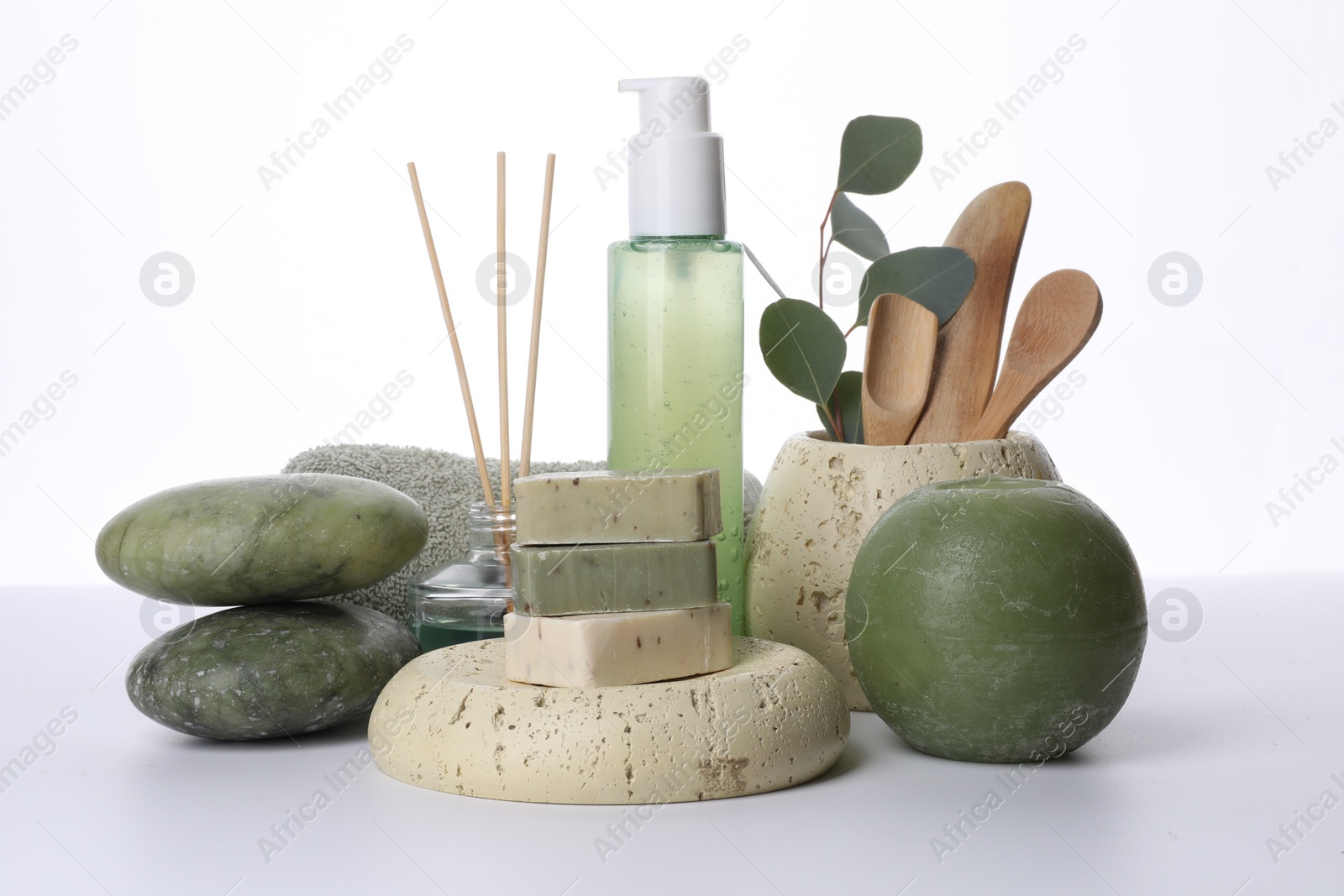 Photo of Composition with spa products, reed air freshener, candle and eucalyptus branch isolated on white