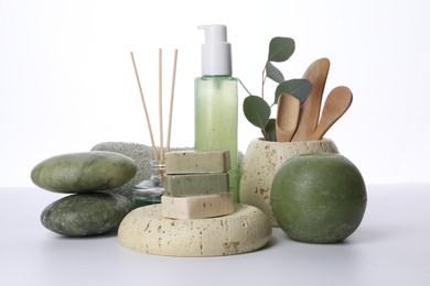 Composition with spa products, reed air freshener, candle and eucalyptus branch isolated on white
