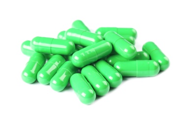 Pile of green pills on white background