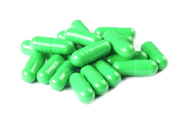 Photo of Pile of green pills on white background