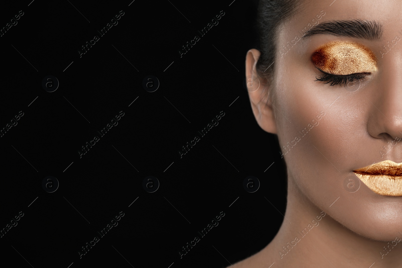 Image of Young woman with beautiful gold makeup on black background, closeup. Space for text