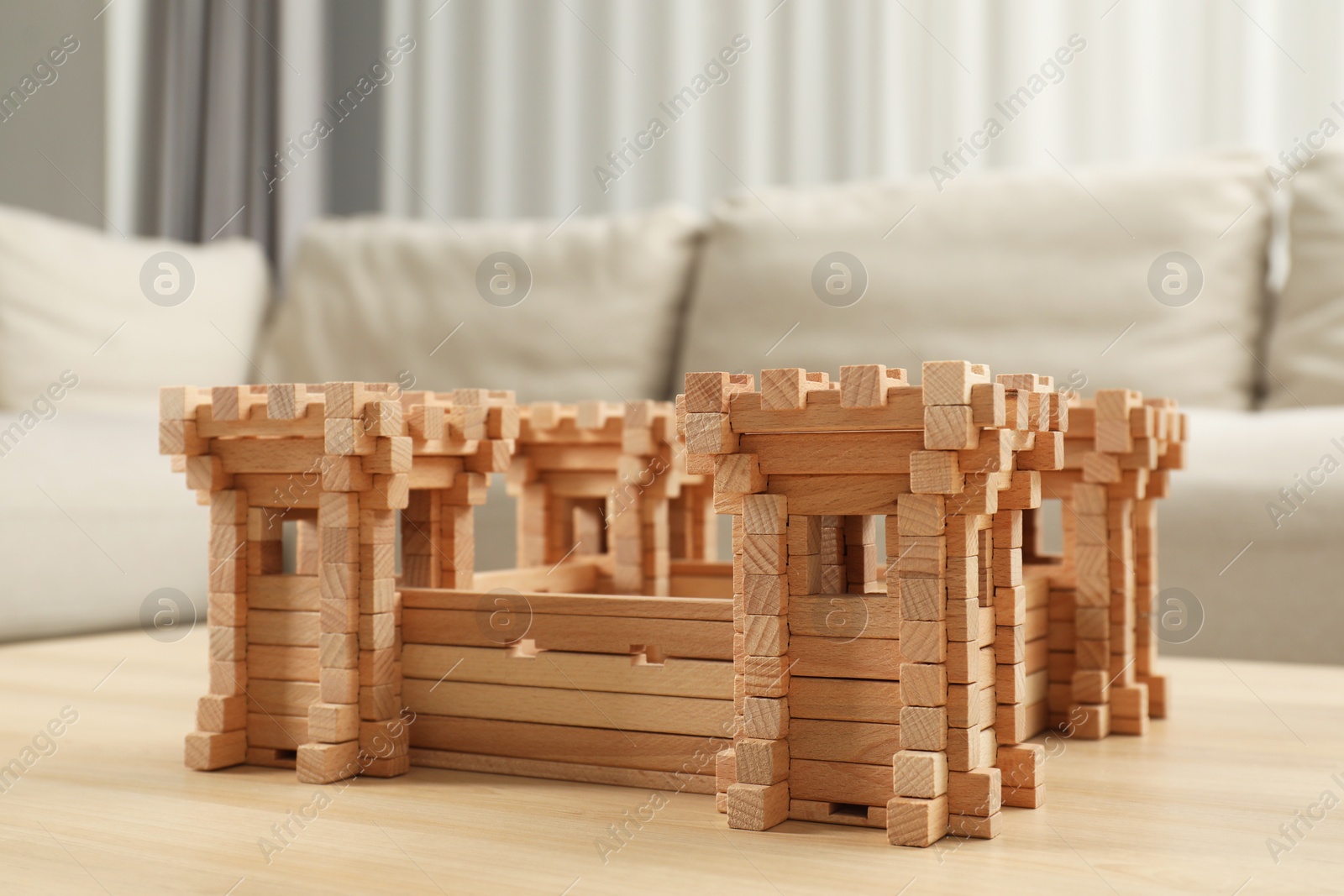 Photo of Wooden fortress on table indoors. Children's toy