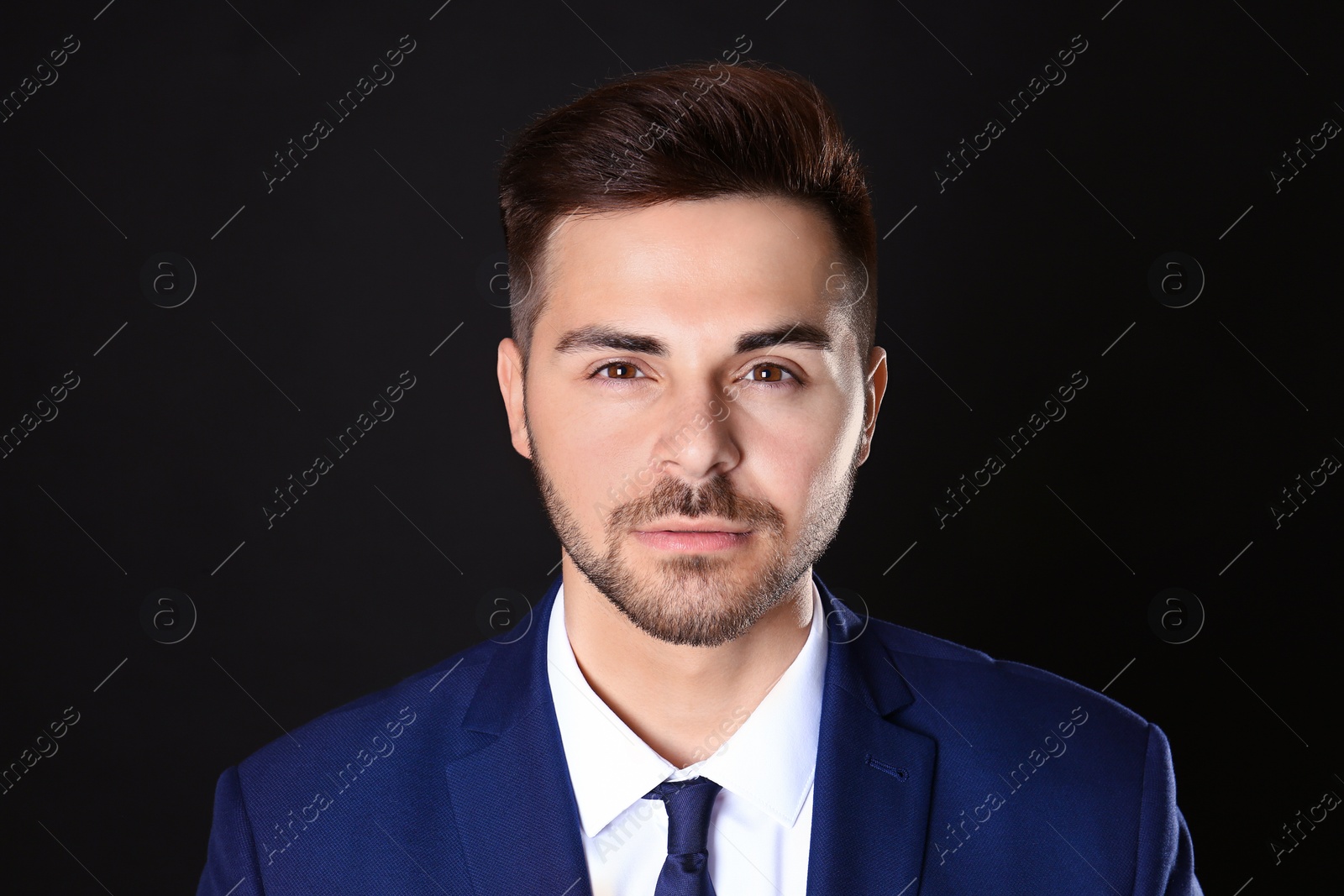 Photo of Portrait of handsome man on black background