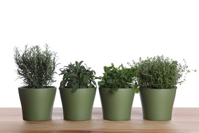 Photo of Pots with thyme, sage, mint and rosemary on wooden table against white background