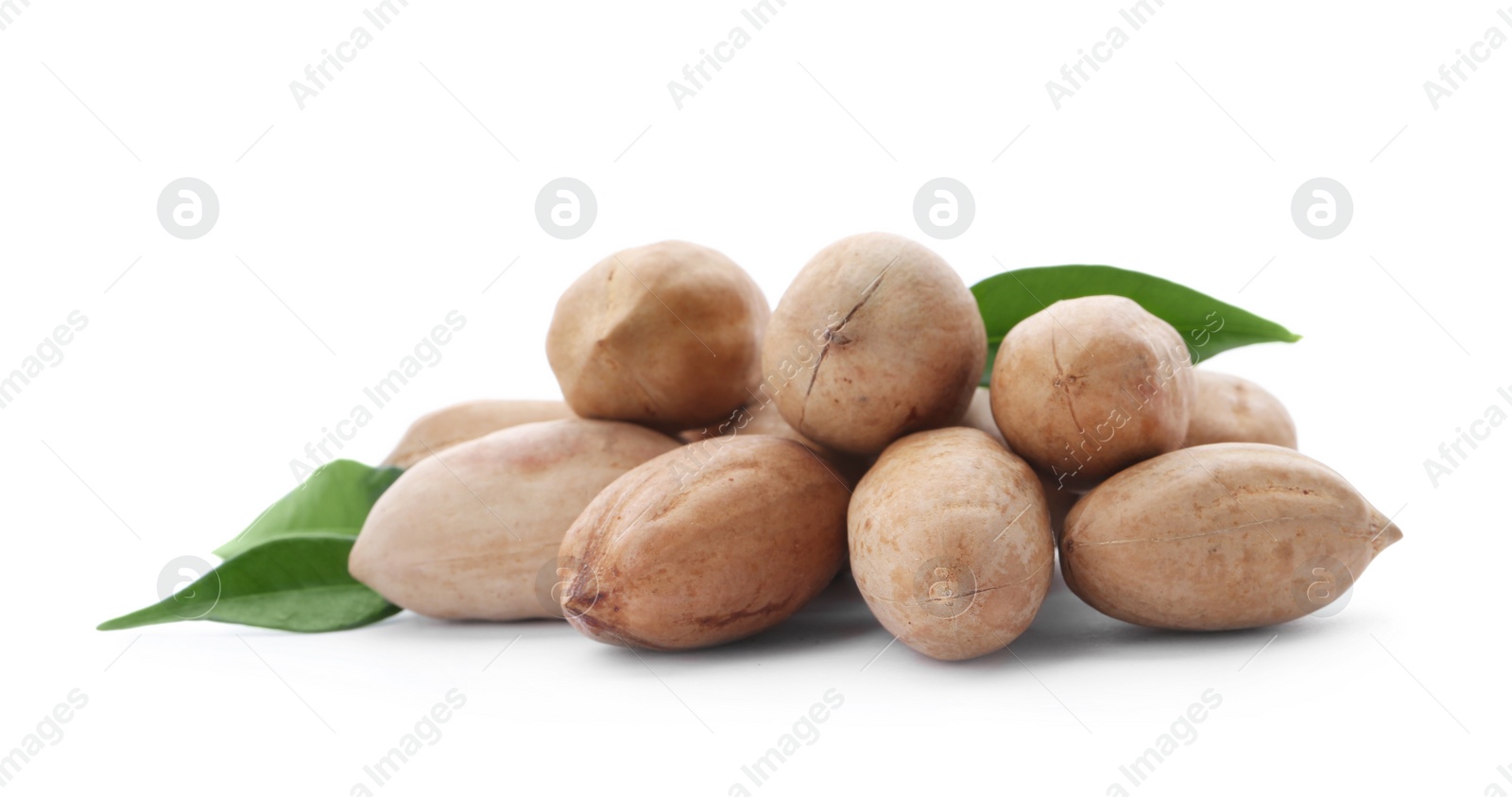 Photo of Heap of pecan nuts in shell and leaves on white background