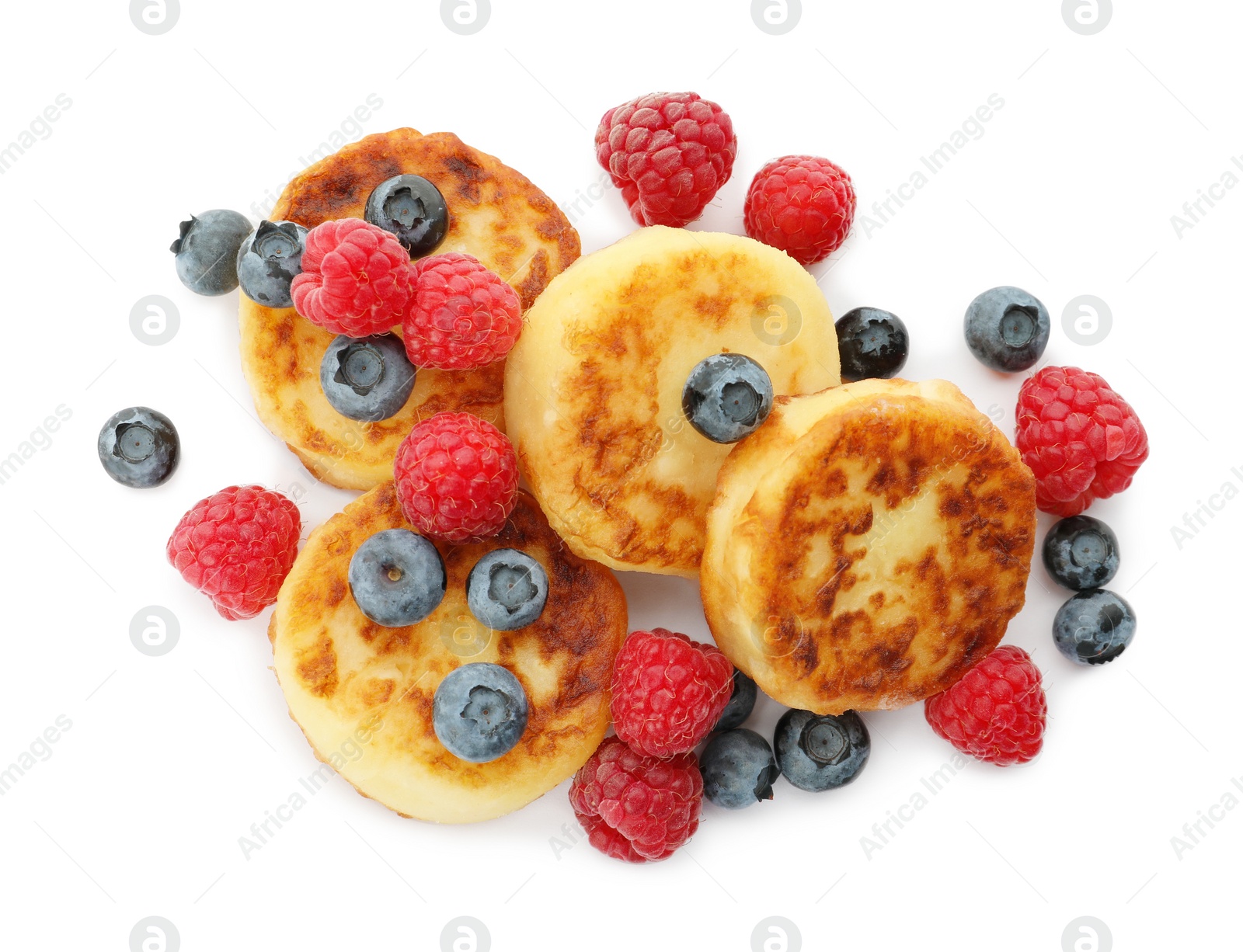 Photo of Delicious cottage cheese pancakes with fresh berries on white background, top view