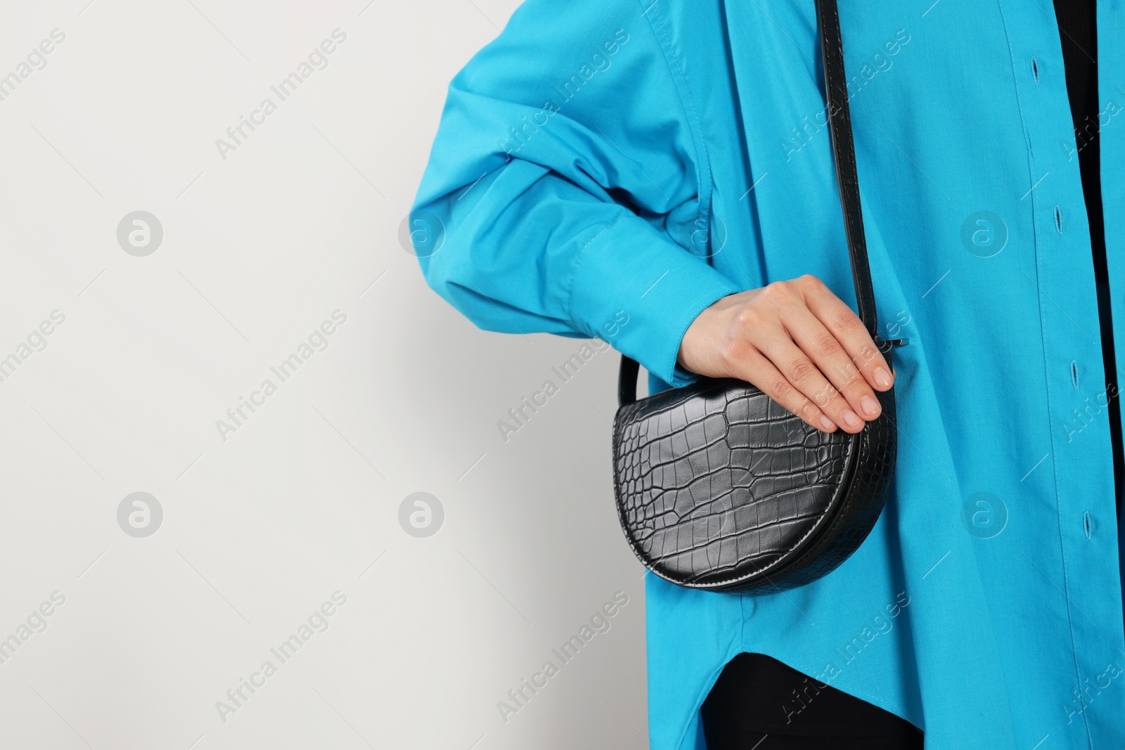 Photo of Woman with stylish bag on white background, closeup. Space for text