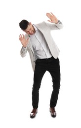 Photo of Emotional man evading something on white background