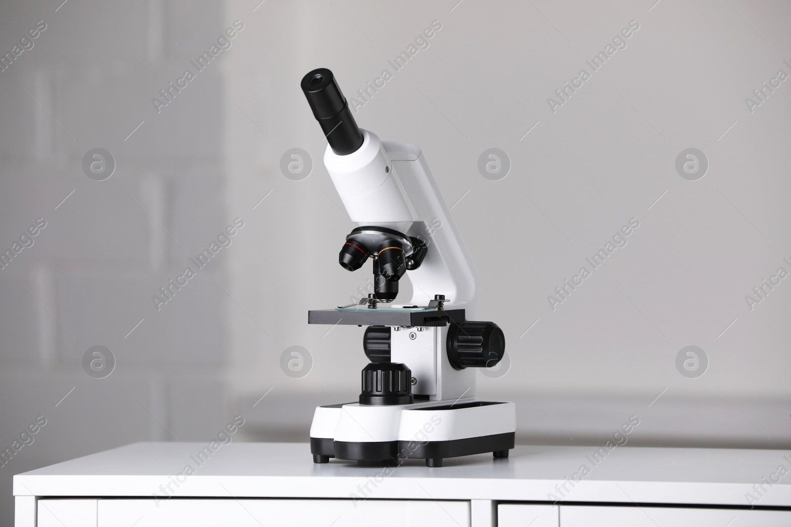 Photo of Modern microscope on table indoors. Medical equipment