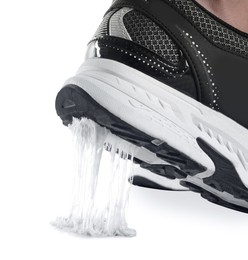 Photo of Person stepping into chewing gum on white background, closeup