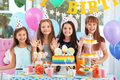 Photo of Happy children at birthday party in decorated room