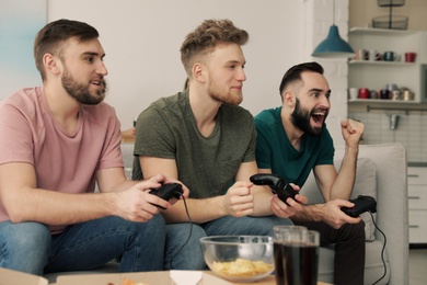 Photo of Emotional friends playing video games at home