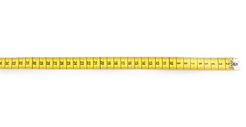 Photo of New yellow measuring tape isolated on white, top view