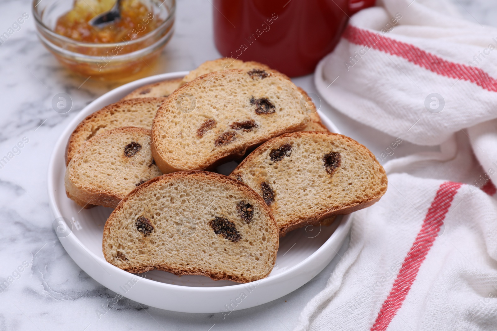 Photo of Sweet hard chuck crackers with raisins on white marble table