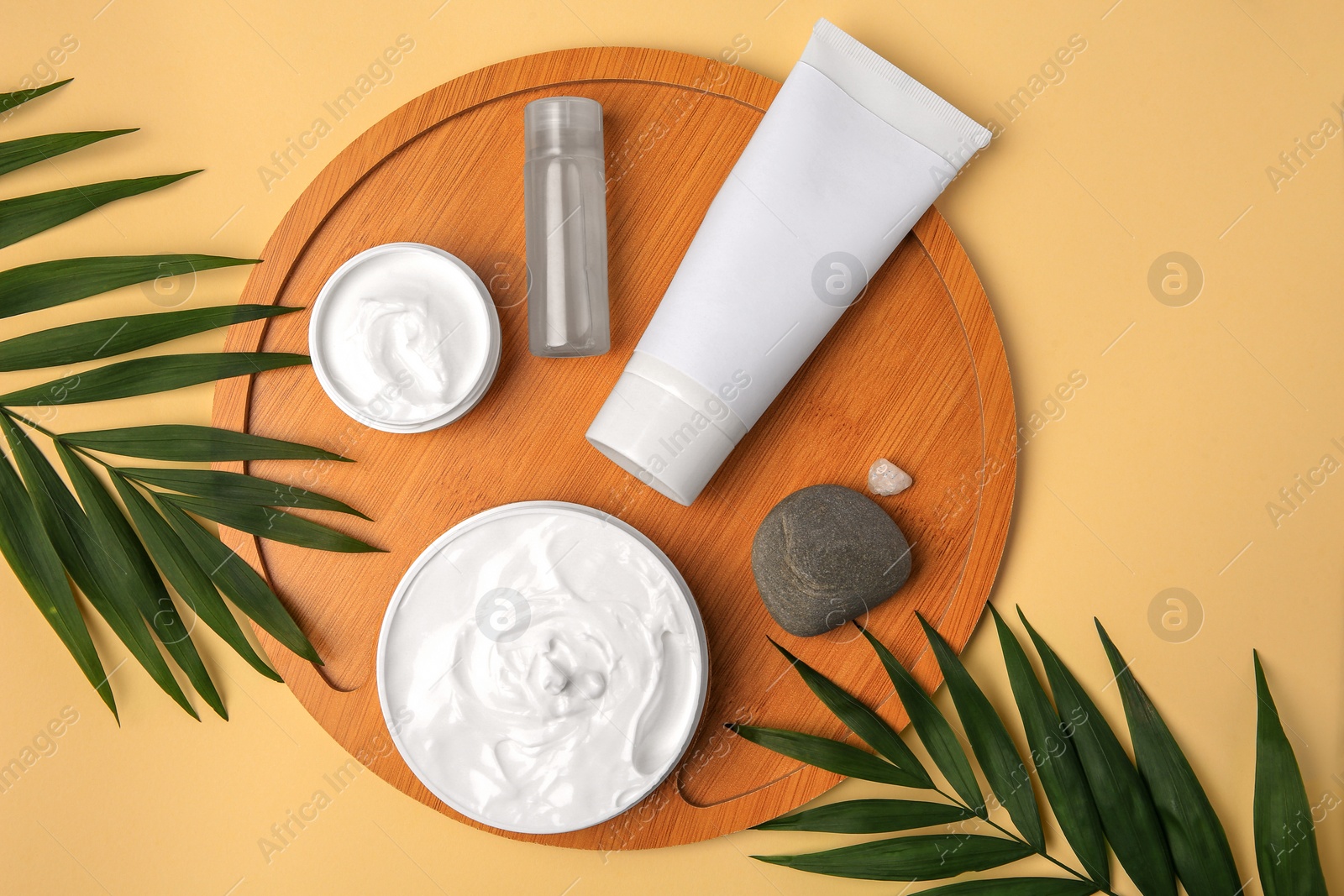 Photo of Flat lay composition with different cosmetic products on beige background