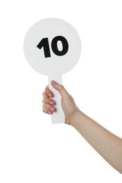 Photo of Woman holding auction paddle with number 10 on white background, closeup