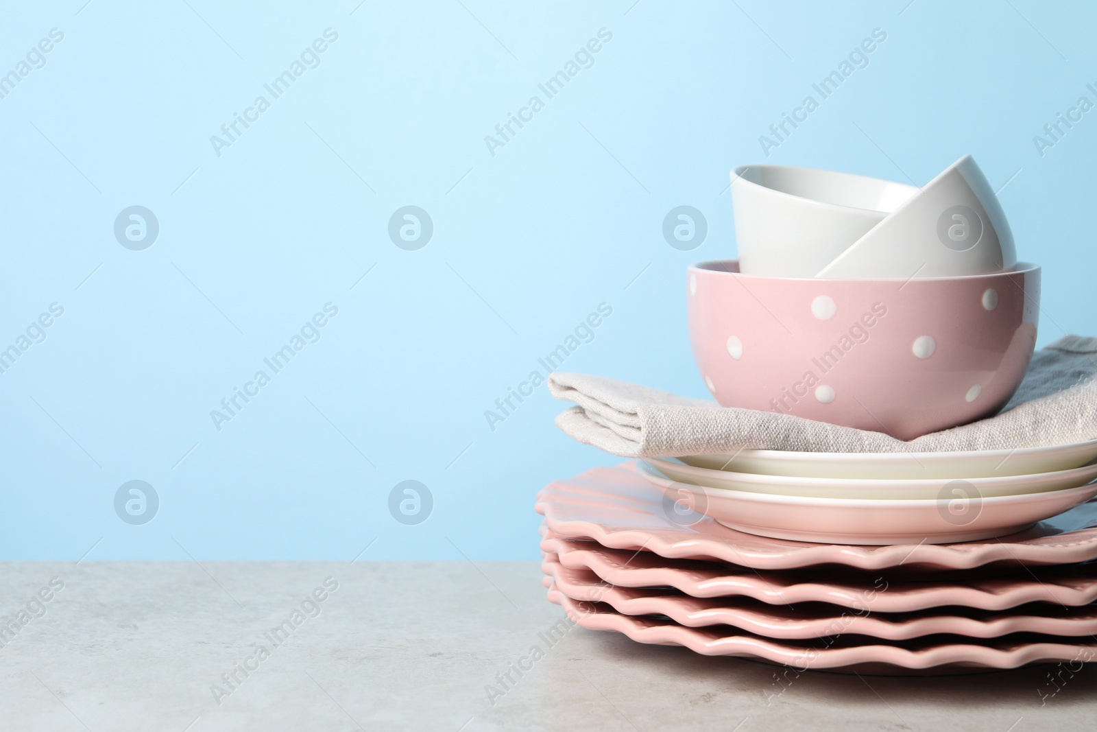 Photo of Beautiful ceramic dishware on light grey table, space for text