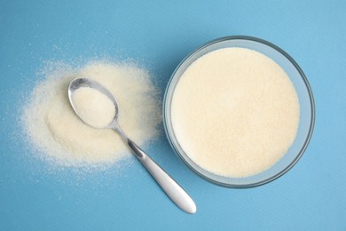 Photo of Gelatin powder on light blue background, flat lay