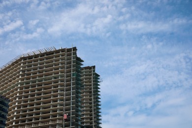 Photo of Construction site with unfinished building on sunny day