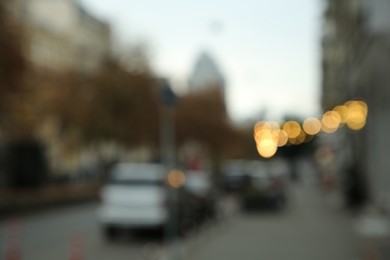 Blurred view of quiet street with beautiful buildings, sidewalk and trees
