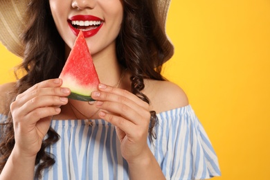 Photo of Beautiful young woman with watermelon on yellow background, closeup