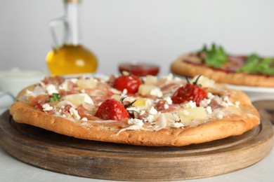 Photo of Delicious homemade pita pizza on light table, closeup