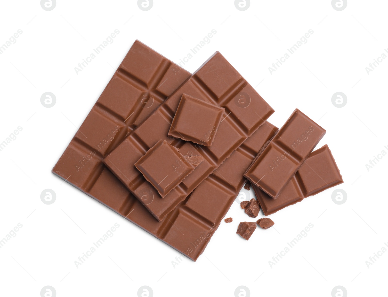 Photo of Pieces of delicious milk chocolate bars on white background, top view