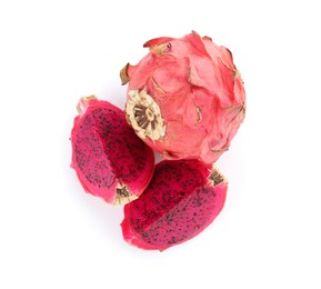 Photo of Delicious cut and whole red pitahaya fruits on white background, top view