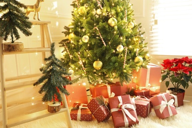 Many different gifts under Christmas tree indoors