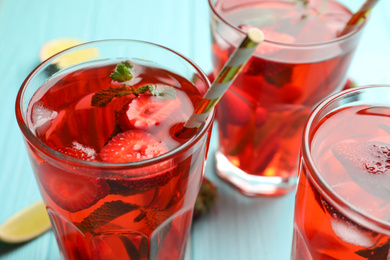 Photo of Refreshing drink with strawberry on table, closeup
