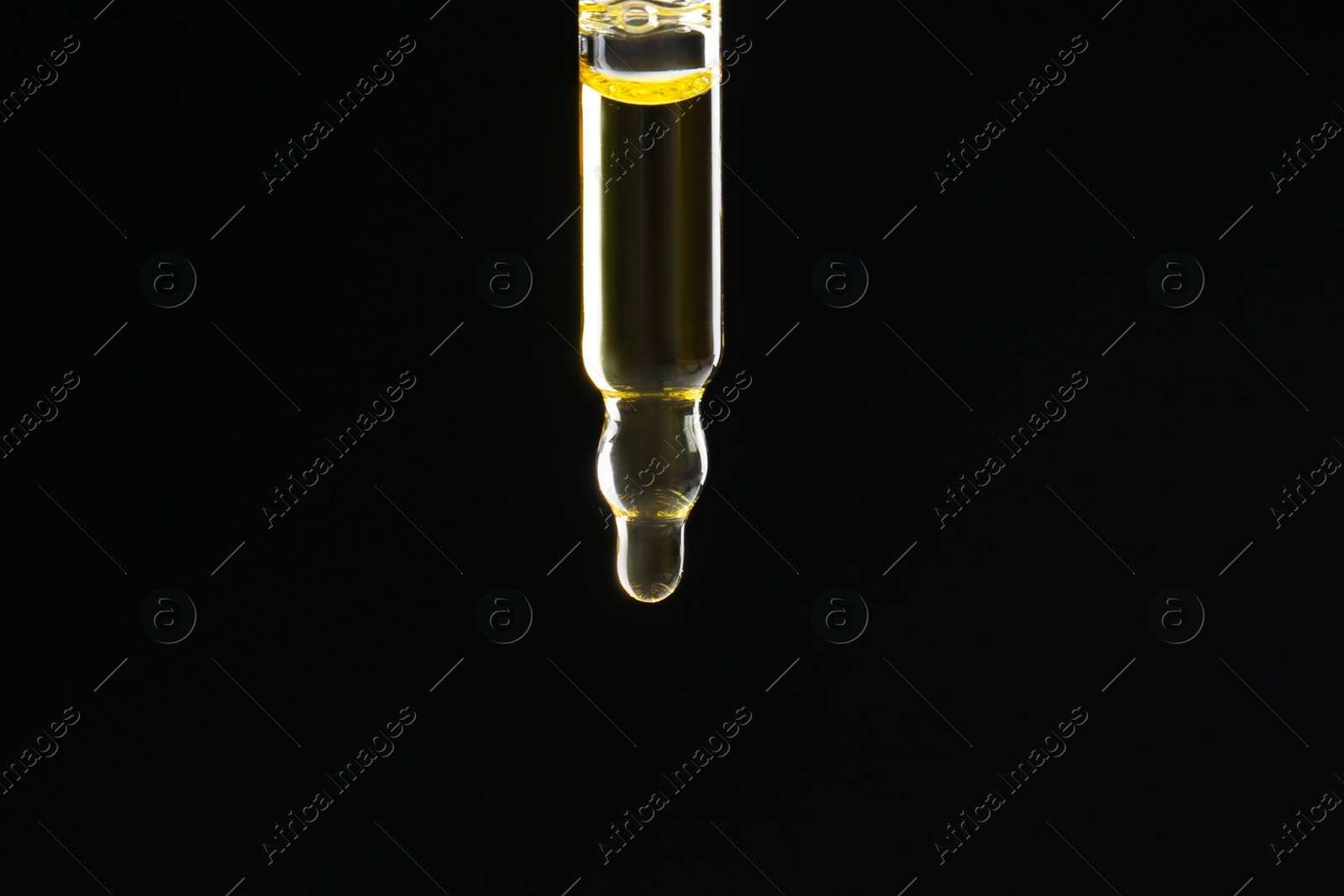 Photo of Pipette with tincture on black background, closeup