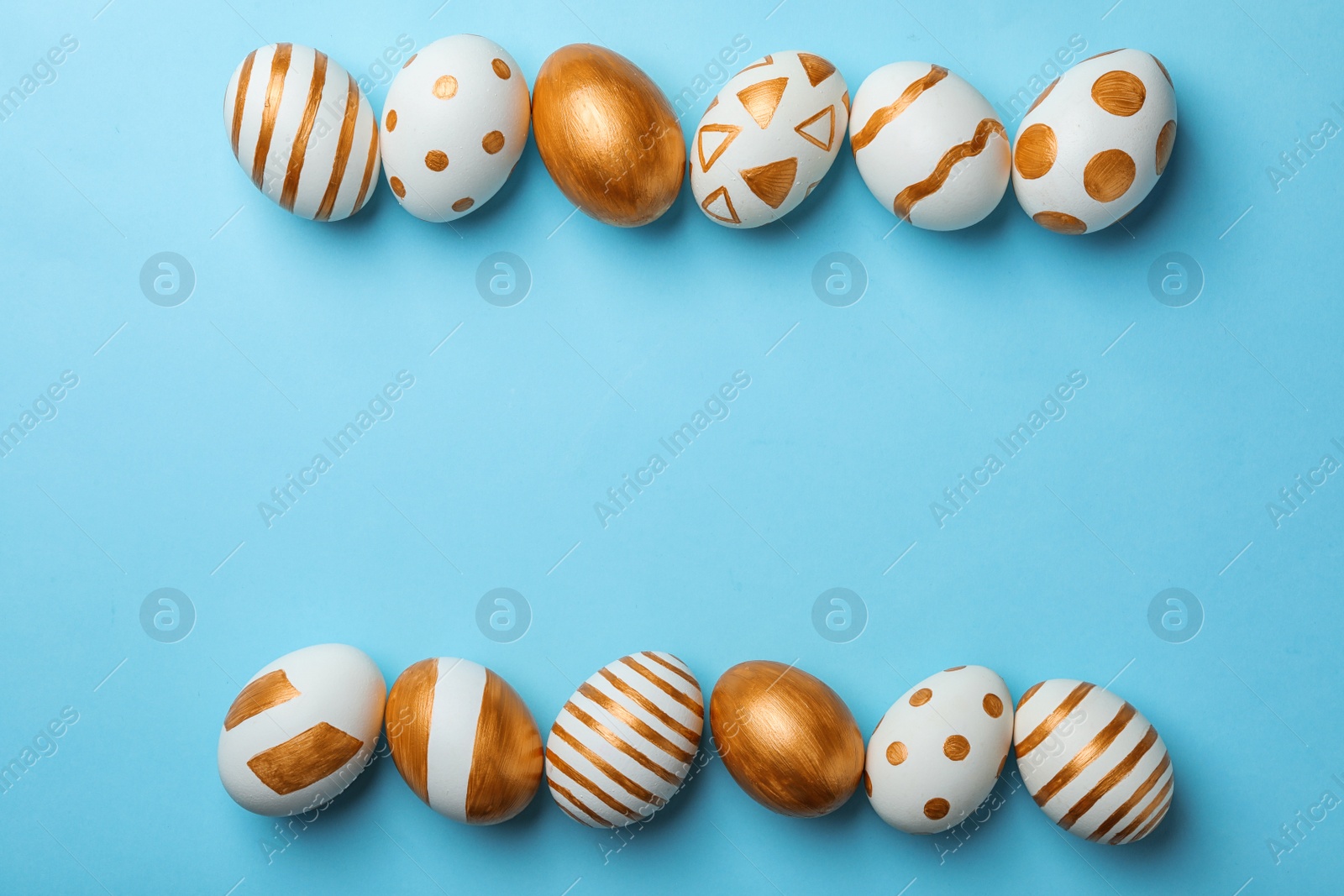 Photo of Set of traditional Easter eggs decorated with golden paint on color background, top view. Space for text