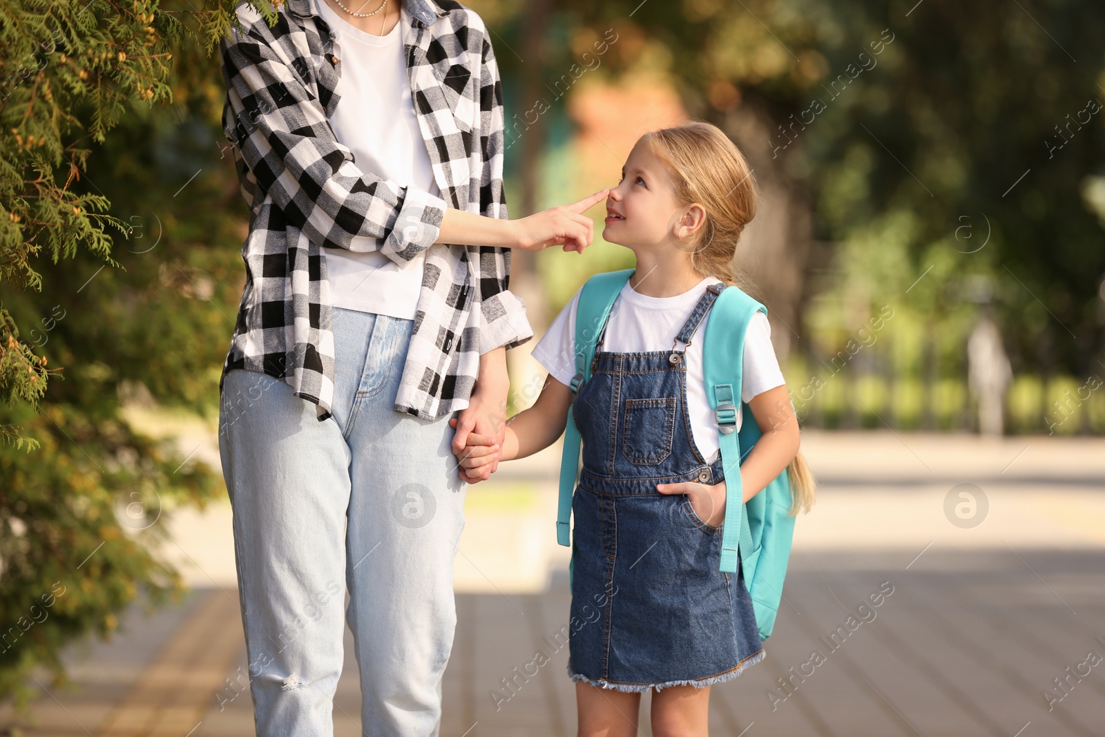 Photo of Little girl with her mother on way to school