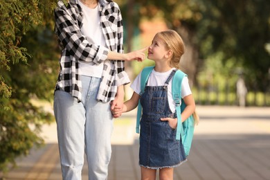 Photo of Little girl with her mother on way to school