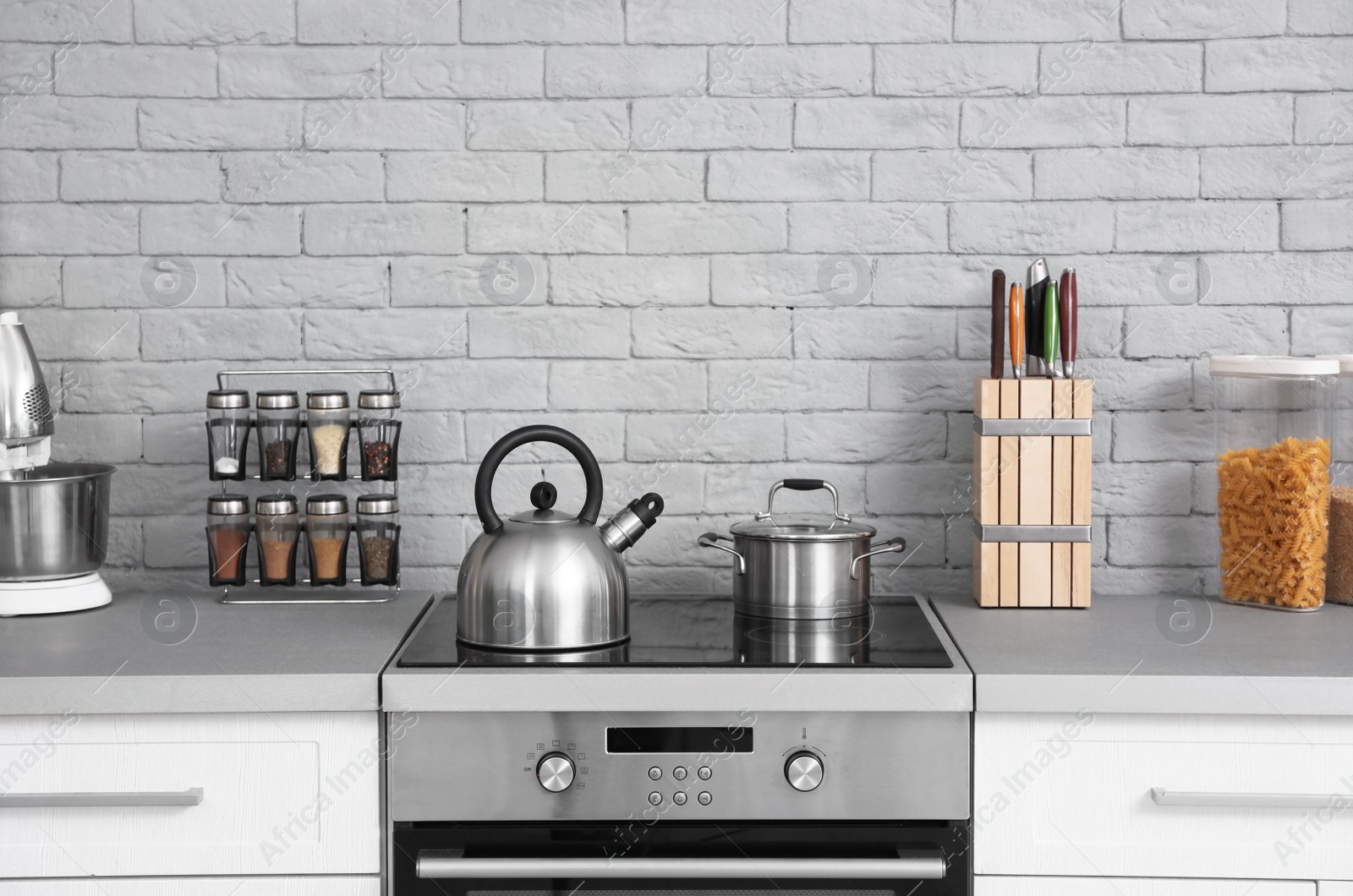 Photo of Modern kitchen interior with new furniture and different utensils