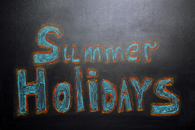 Photo of Inscription Summer Holidays written on blackboard. School break