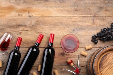 Photo of Winemaking. Flat lay composition with tasty wine and barrel on wooden table, space for text