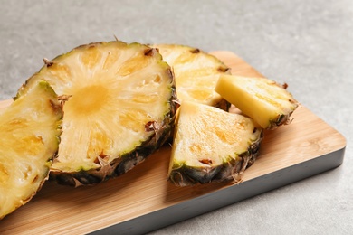 Slices of fresh pineapple on wooden board