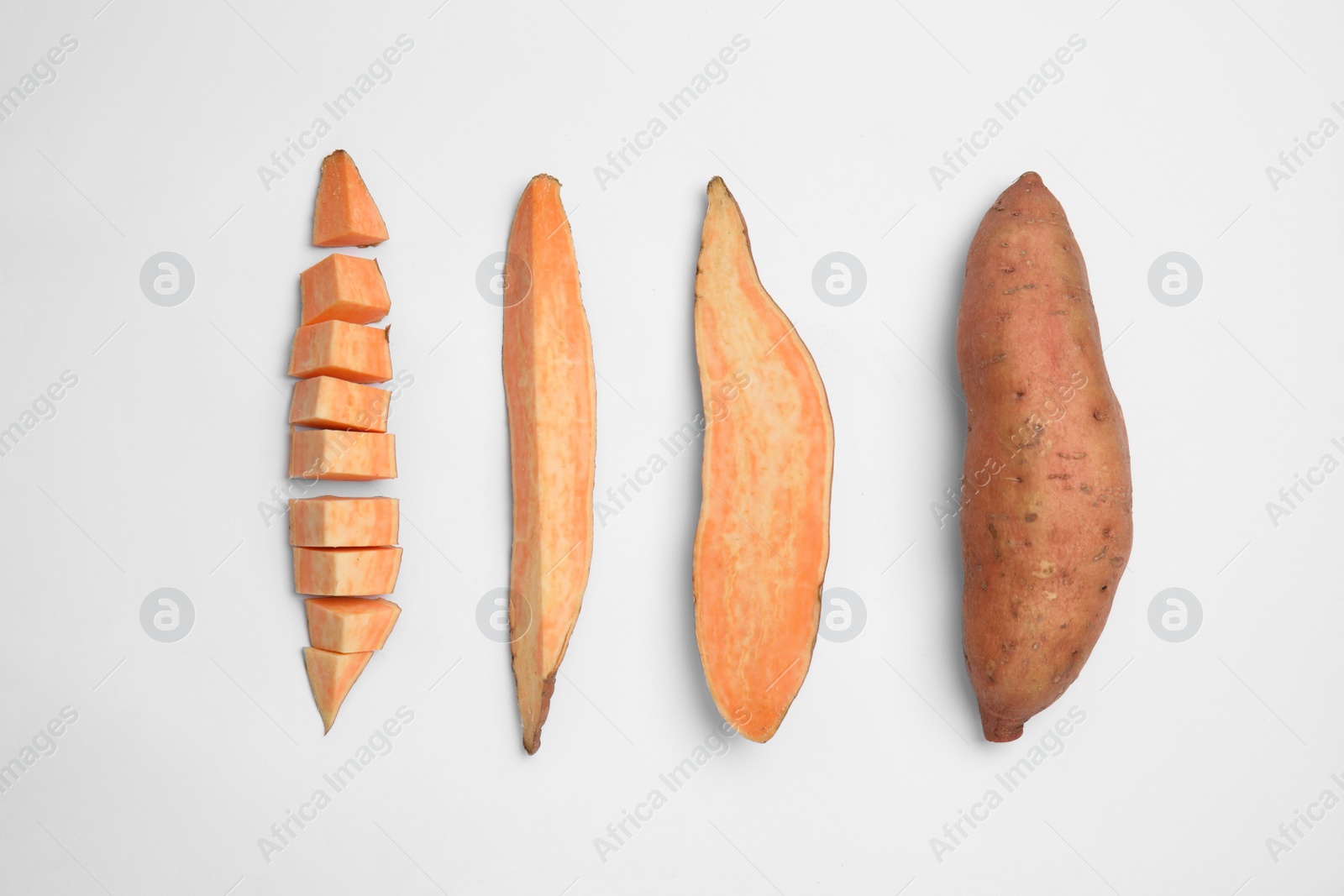 Photo of Cut and whole sweet potatoes on white background, top view