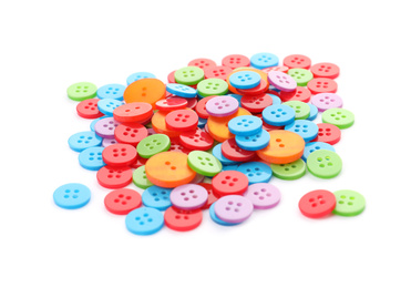 Photo of Many colorful plastic sewing buttons isolated on white