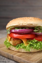 Photo of Delicious burger with tofu and fresh vegetables on table, closeup